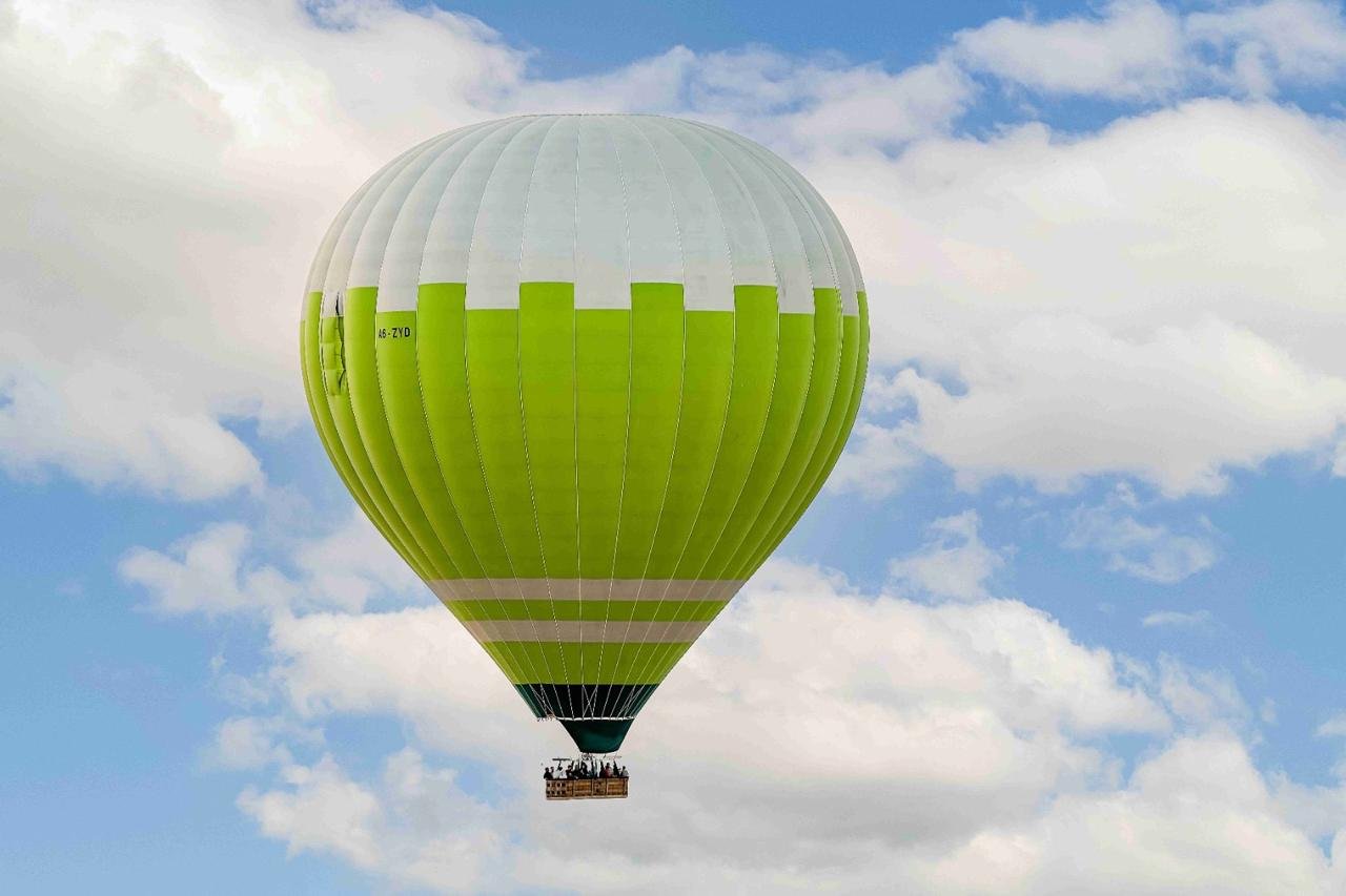 Hot air balloon floating above the clouds
